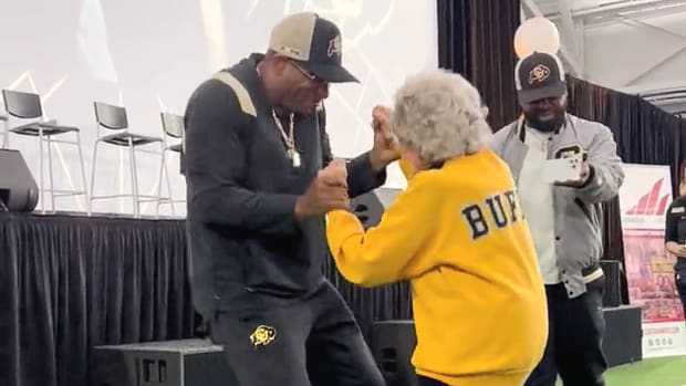 Deion Sanders dancing with Peggy Coppom at CU's kickoff luncheon